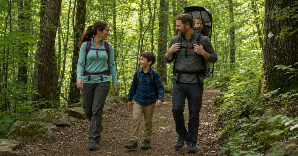 family hiking with kids on a shaded trail