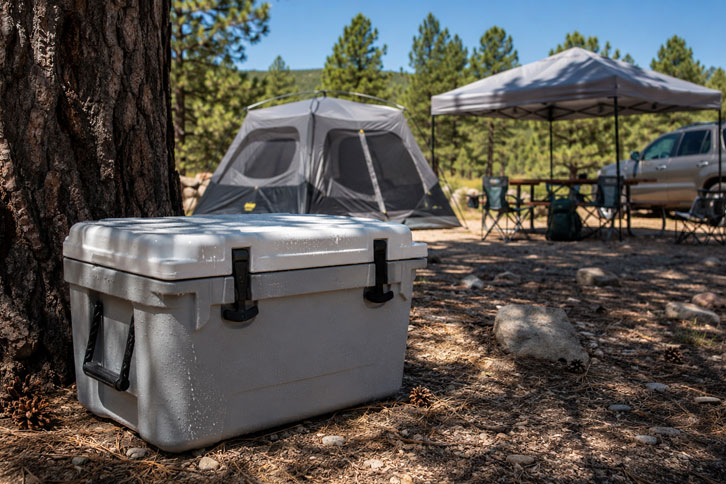 camping cooler stored in shade to keep ice from melting - How to Keep Ice in Your Cooler
