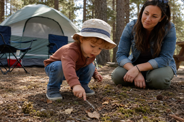toddler playing at a family campsite