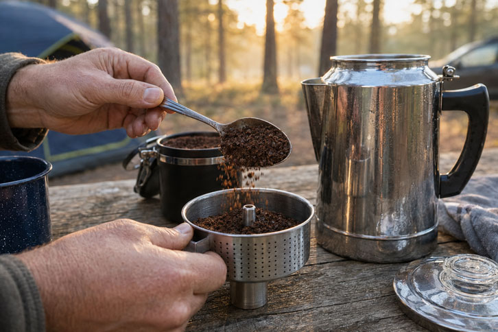 filling a camping percolator basket with coarse ground coffee